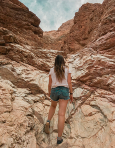 Hiking up the golden cliffs in Death Valley National Park