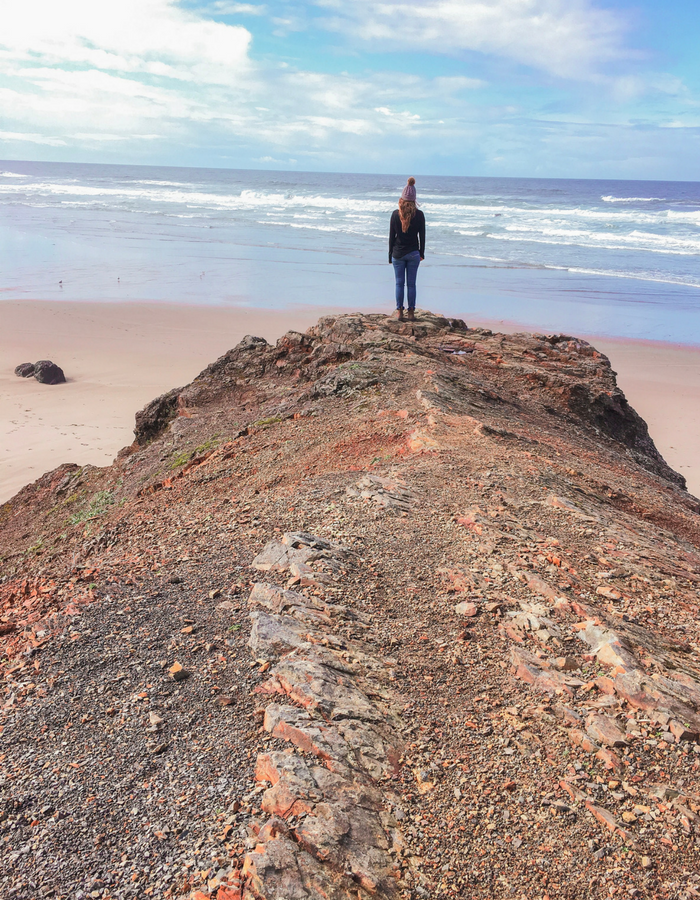 Standing on a cliff edge in Cape Kiwanda on the Oregon Coast