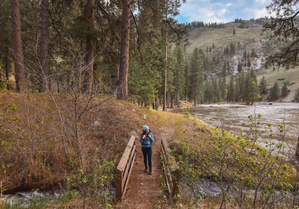 Crossing a small wooden bridge while backpacking in Idaho